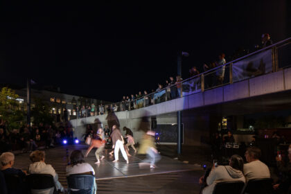 photograph of evening dance performance in plaza