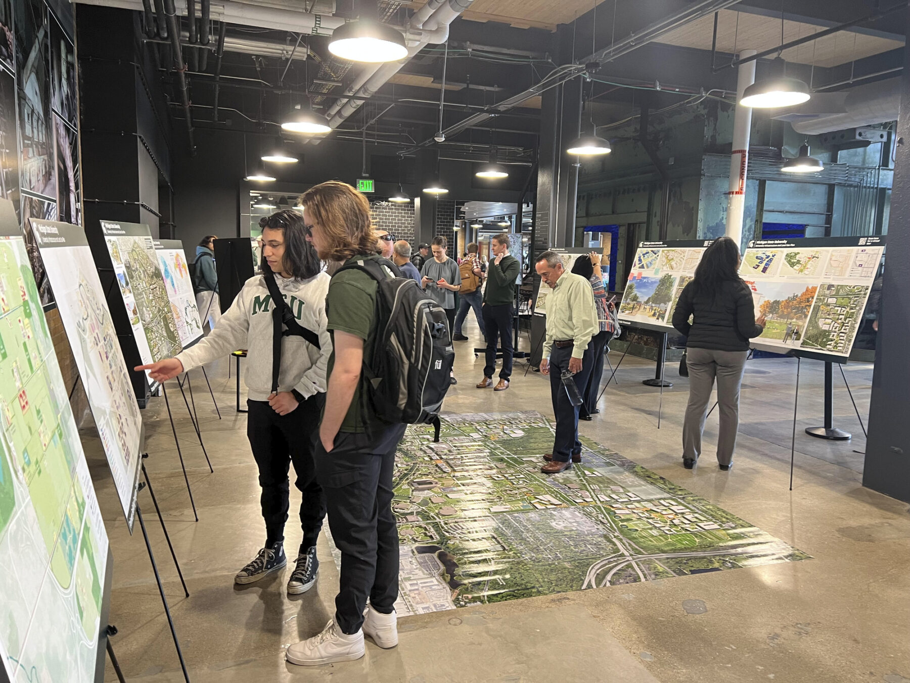 photograph of engagement session with participants interacting with framework maps and diagrams