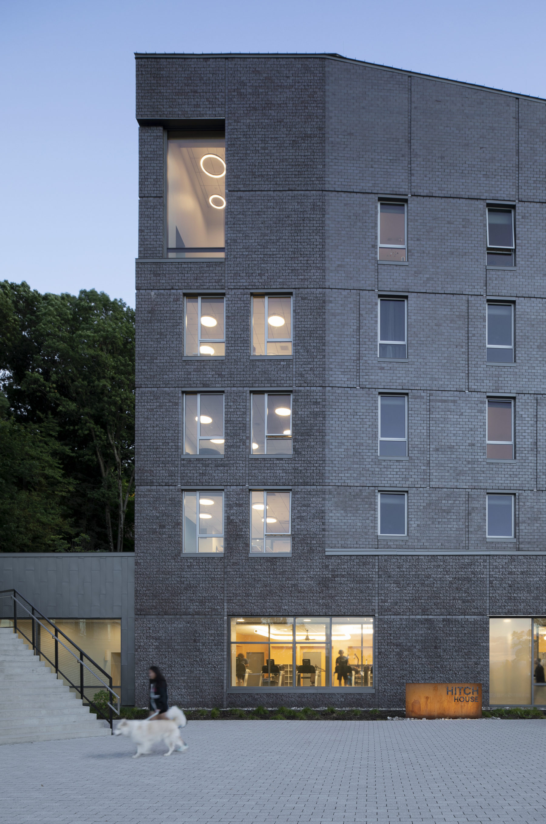 Exterior image of building from courtyard at dusk