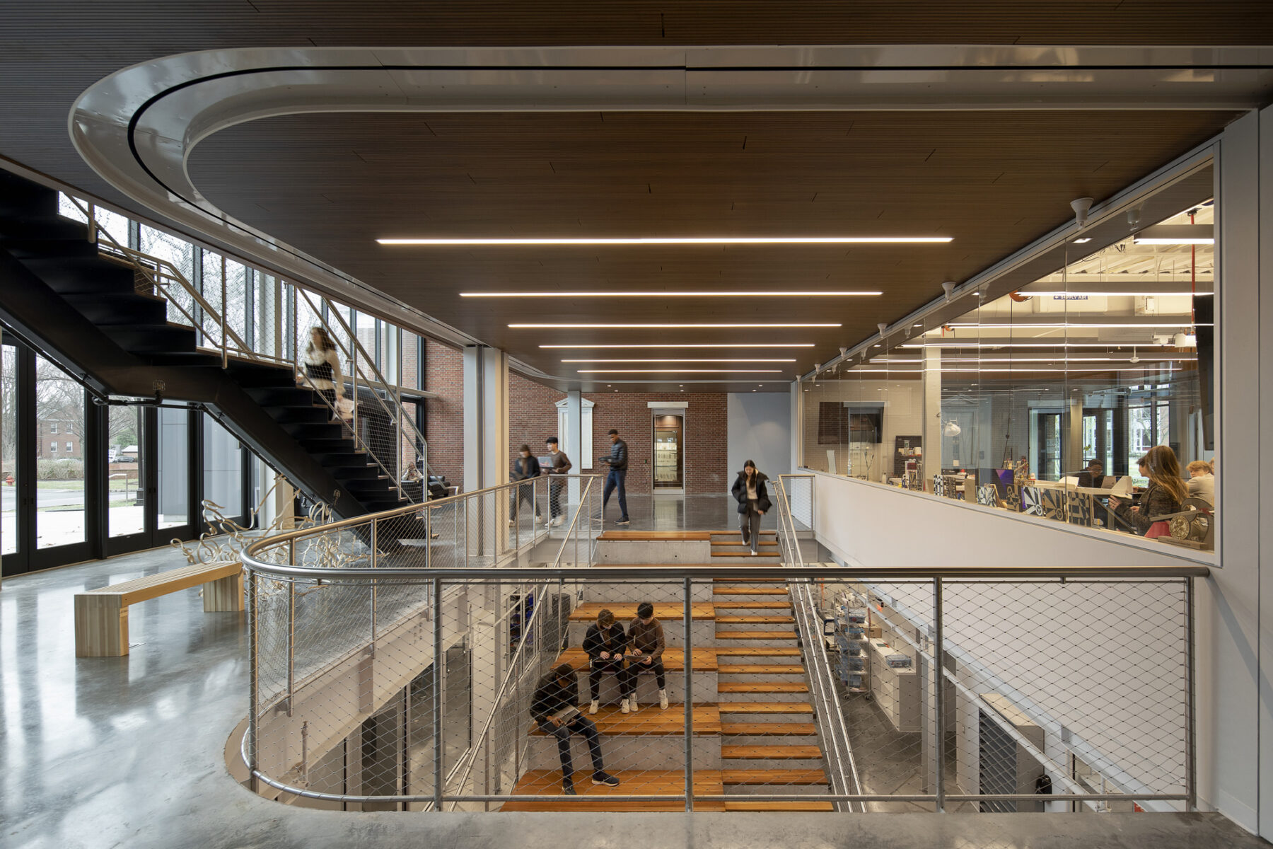 Interior photo across from the top of the stair. A woman walks down the stair