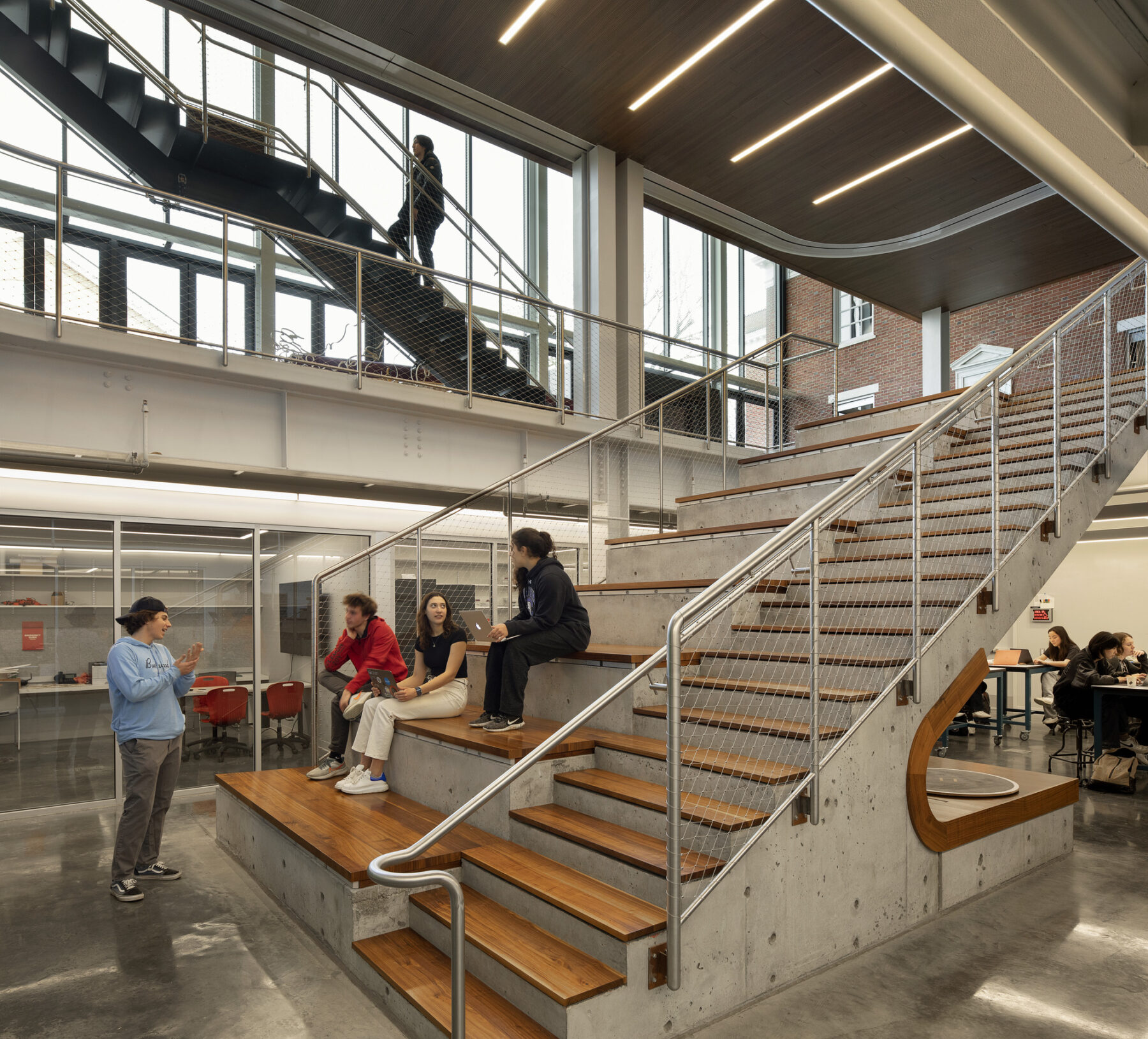 Interior photo at bottom of stairs, concrete stairs with wood