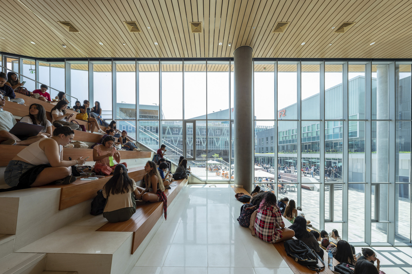 photograph of main auditorium seating inside innovation center with students crowded along seating