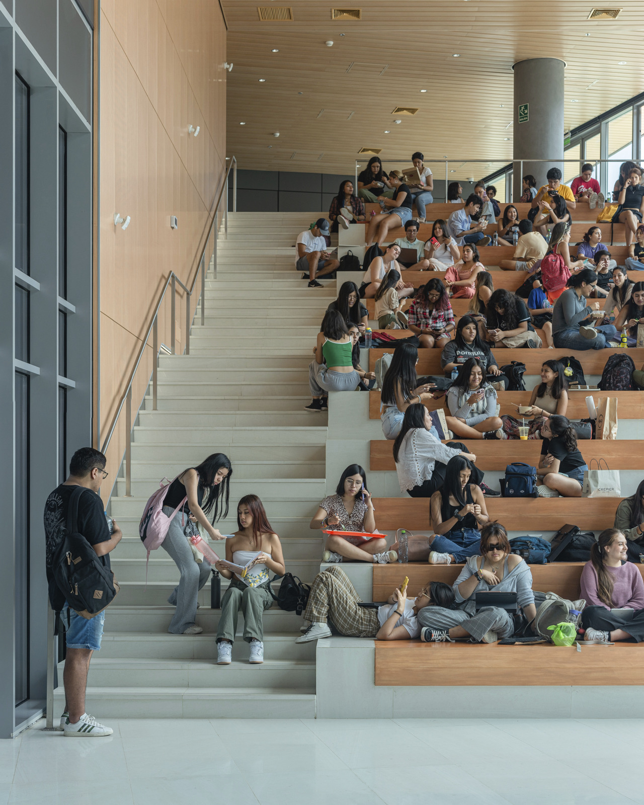 photograph of main auditorium seating inside innovation center with students crowded along seating