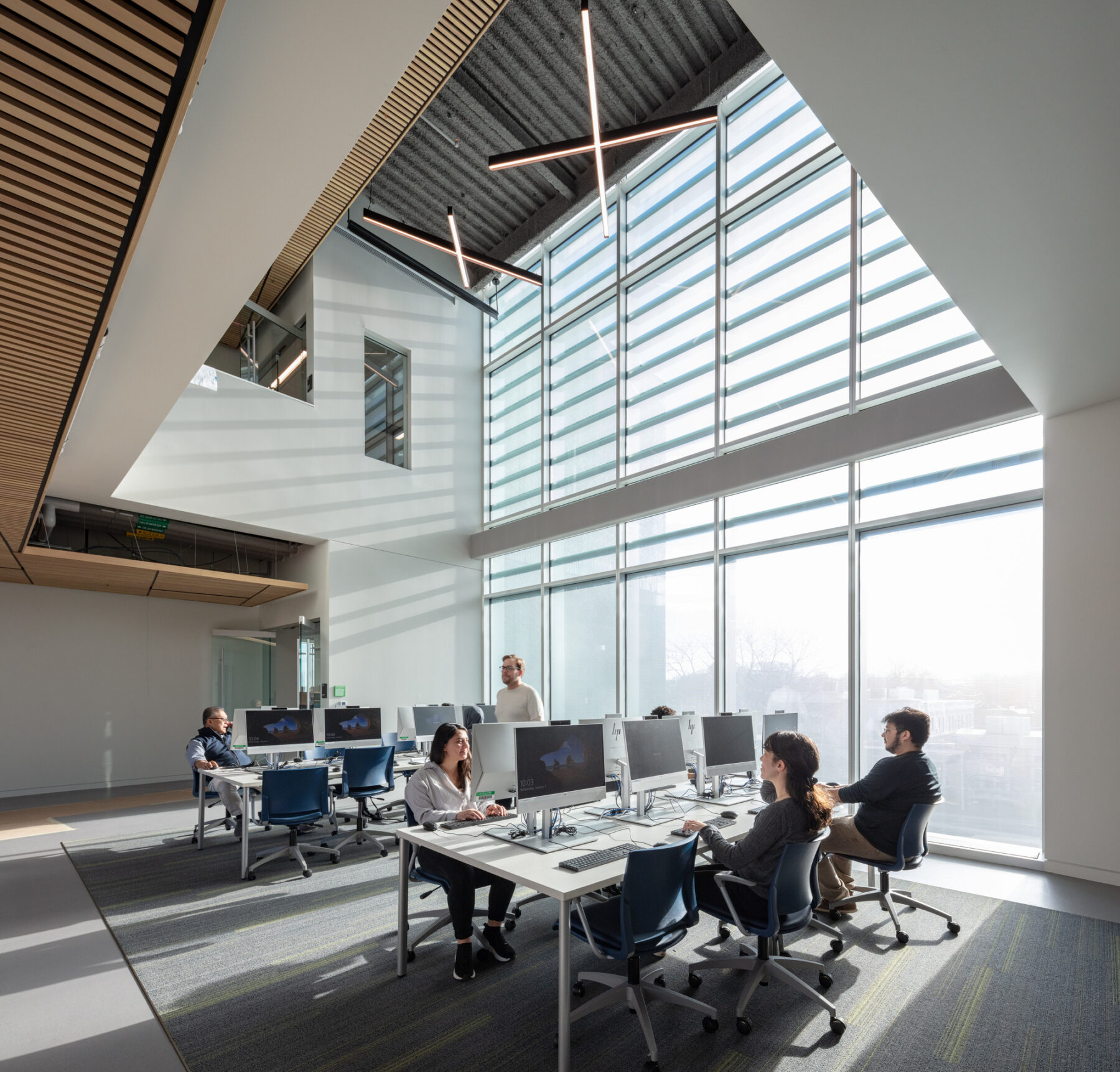 photograph of study area with students seated on tables with desktops