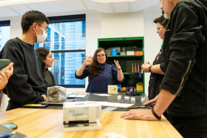 Photo of one person presenting their design in the fabrication studio