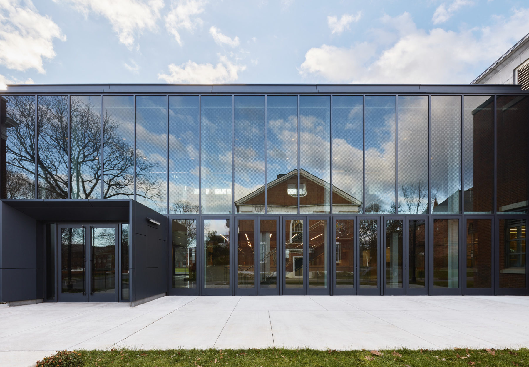 Exterior photo of addition facade reflecting adjacent buildings